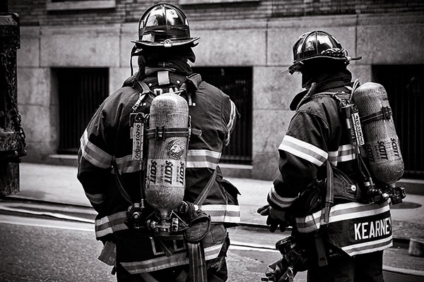 Firefighters standing in full protective gear