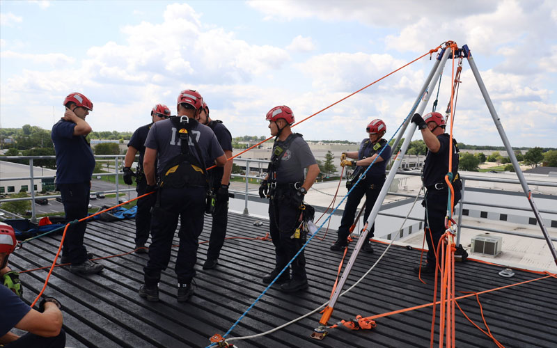 Firefighters conducting rooftop rope rescue training