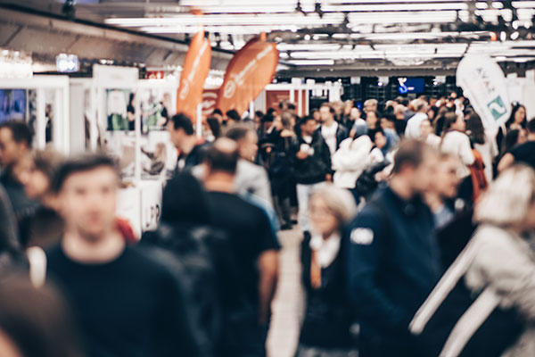 Crowded indoor trade show exhibition hall